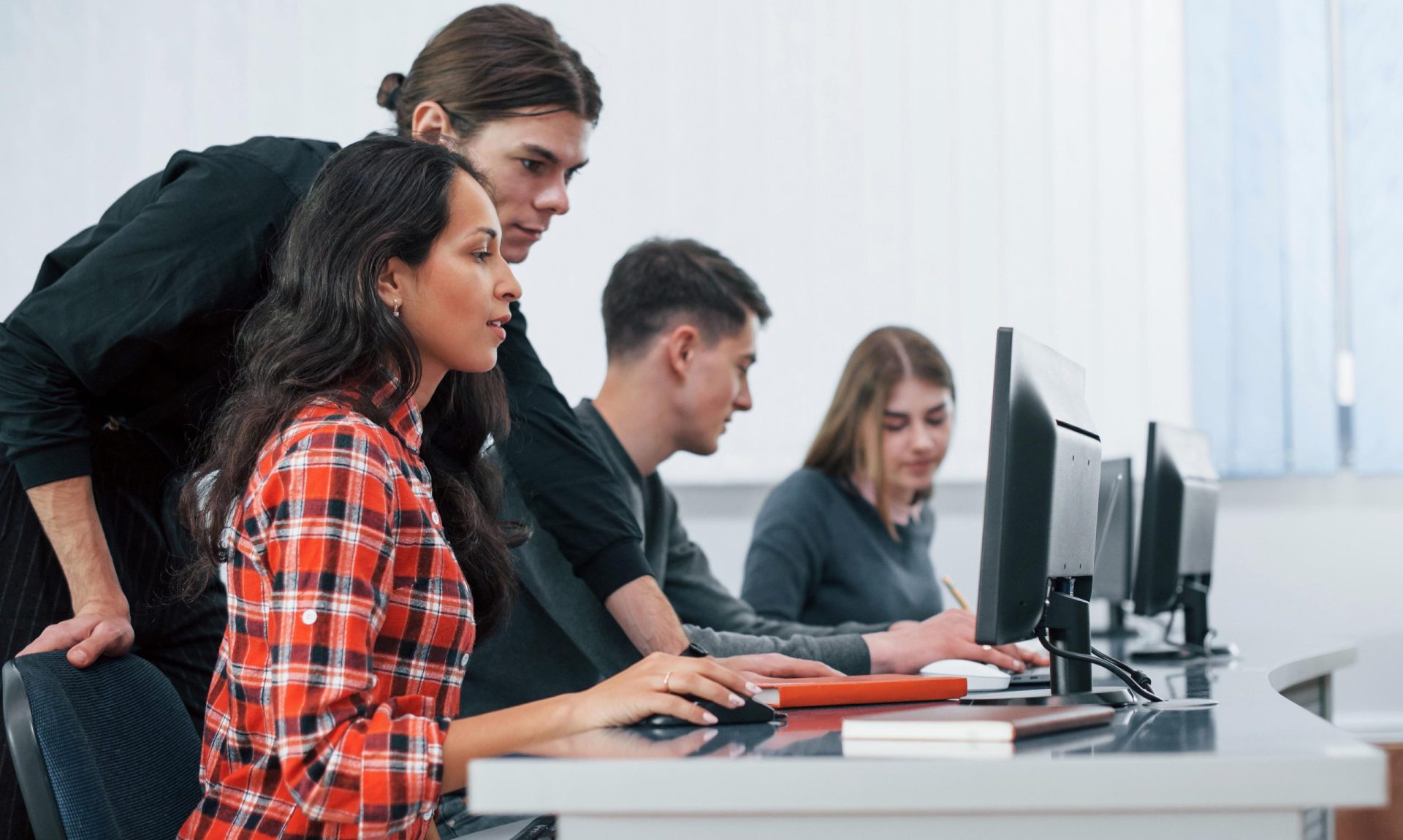 Am I doing it right. Group of young people in casual clothes working in the modern office.